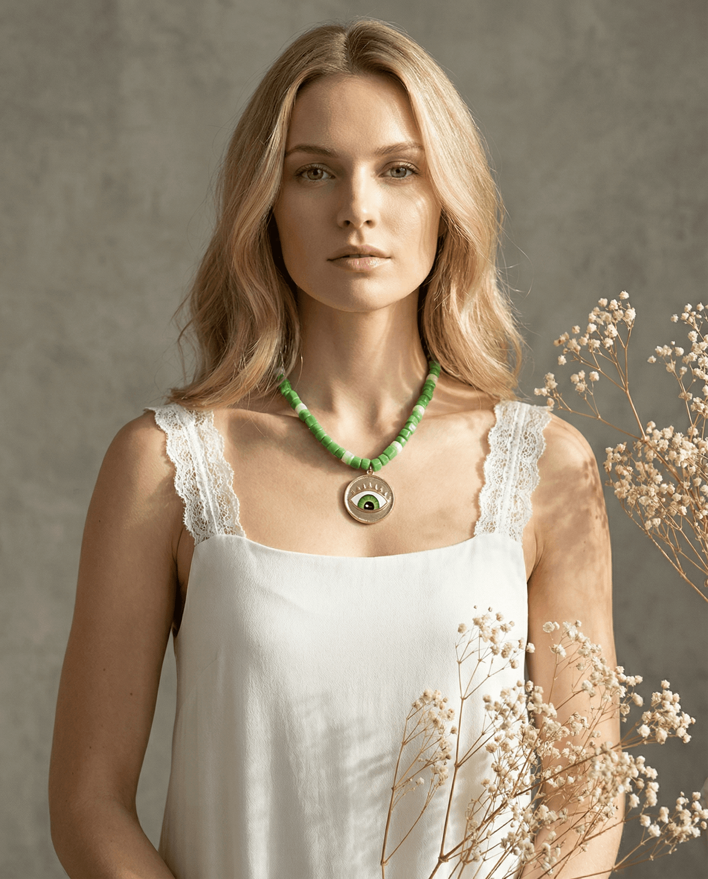 Evil Eye Perlenhalskette an einer jungen Frau, die natürliche Schönheit und Individualität verkörpert.