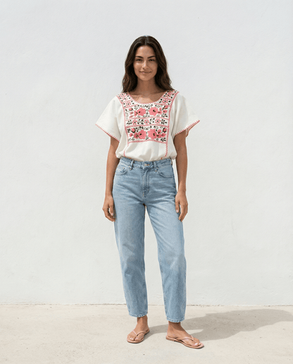 Handbestickte Baumwollbluse Nr. 13 – Creme/Rosa getragen von einer Frau in jeans, im zeitlosen Slow Fashion Stil.